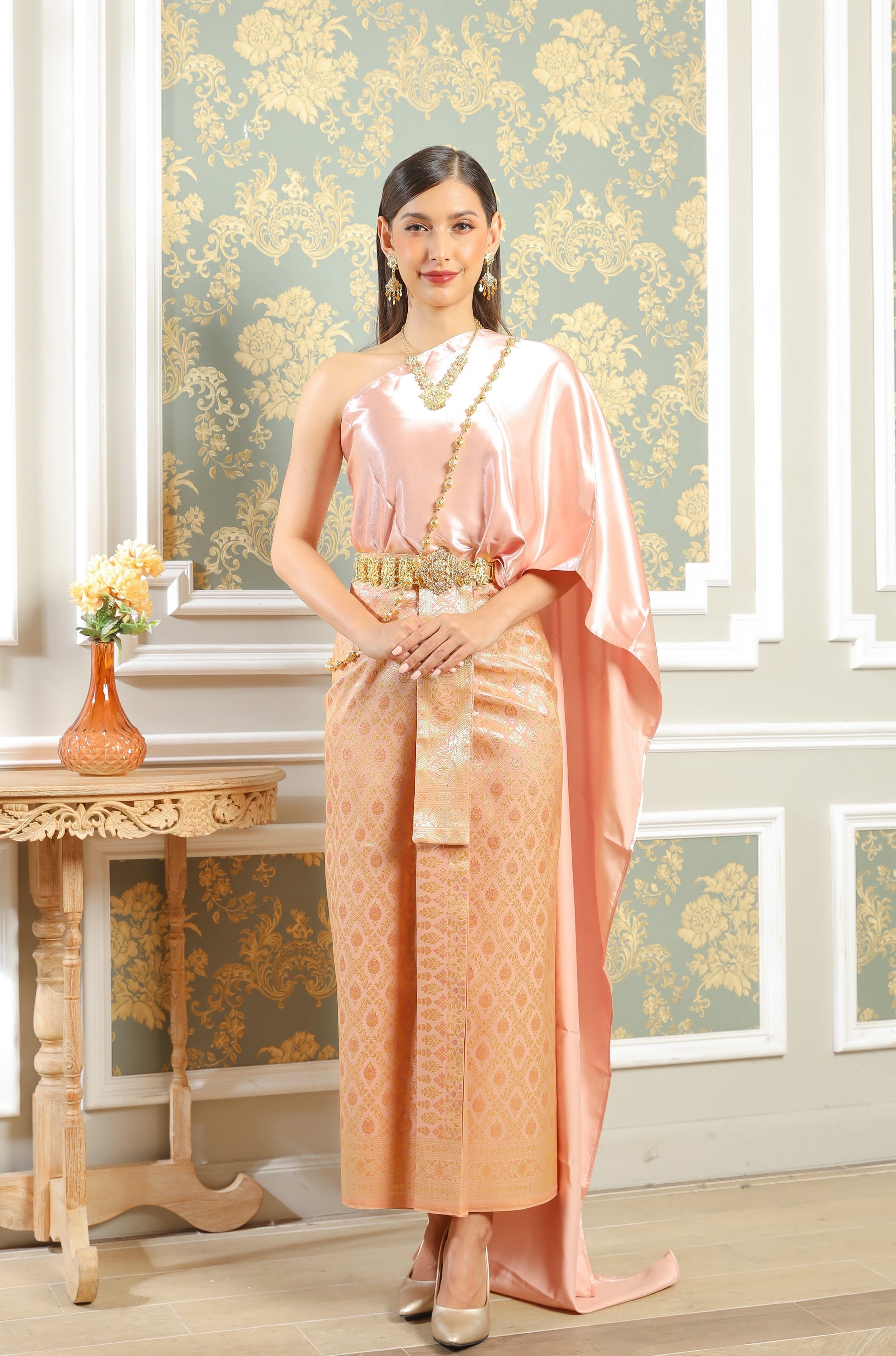 A rose gold traditional Thai outfit for women.
