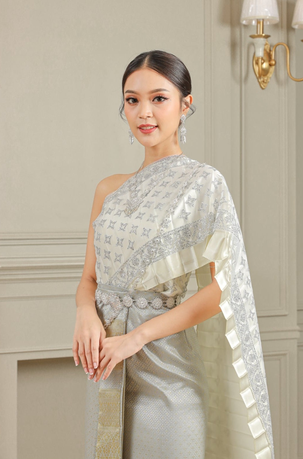 Image of woman wearing a silver traditional Thai dress