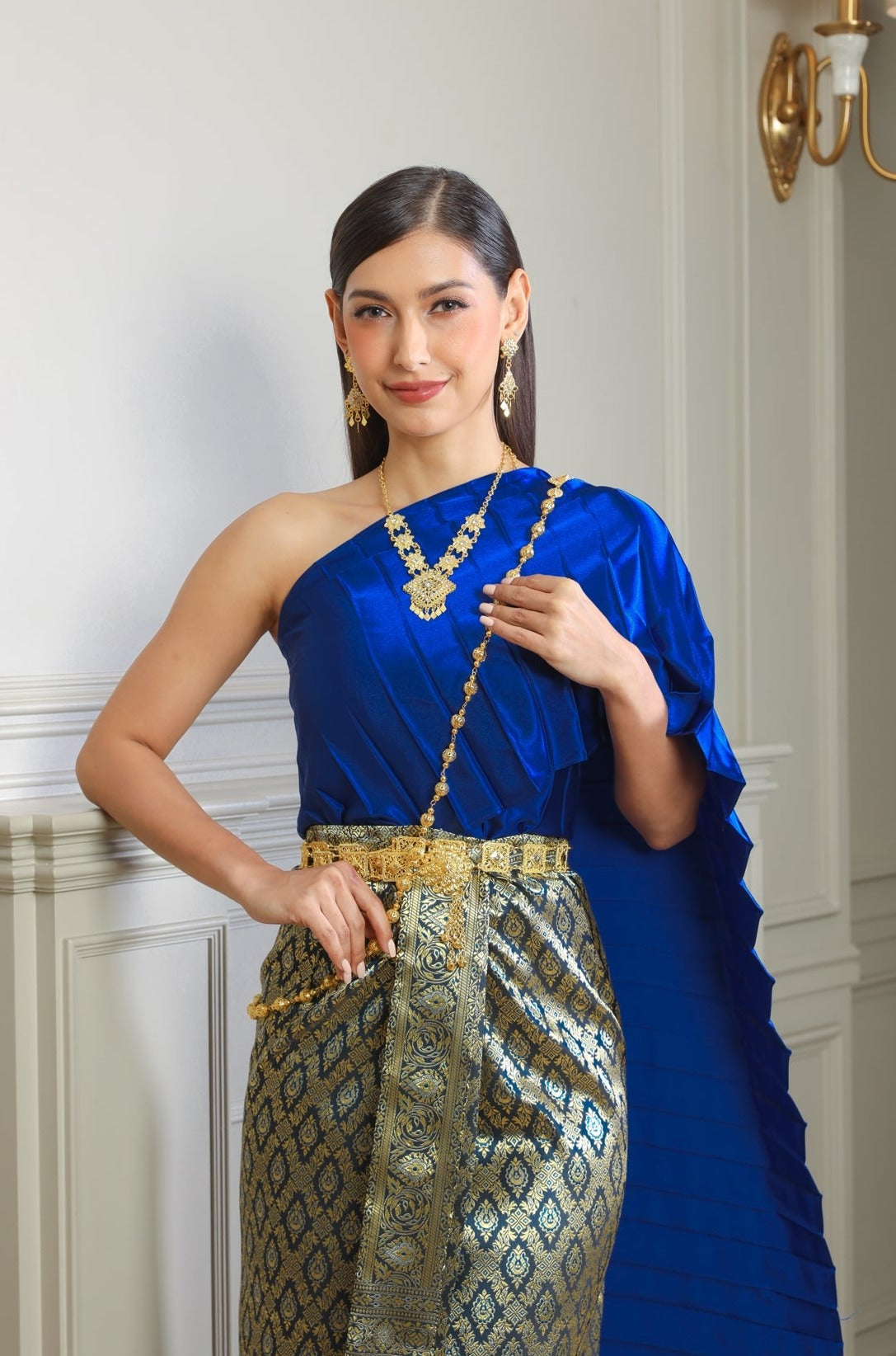Image of a woman wearing a blue traditional Thai dress