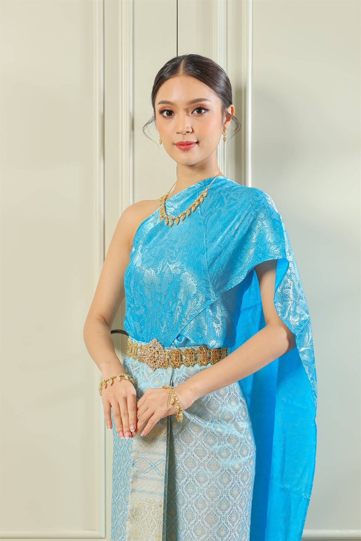 A woman wearing traditional Thai clothing found in Thailand.